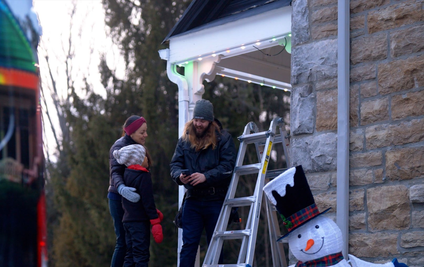 Celebright dealer speaking with a homeowner during a permanent outdoor lighting installation