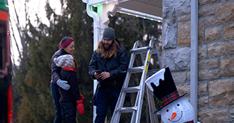 Celebright dealer speaking with homeowners during a permanent lighting installation
