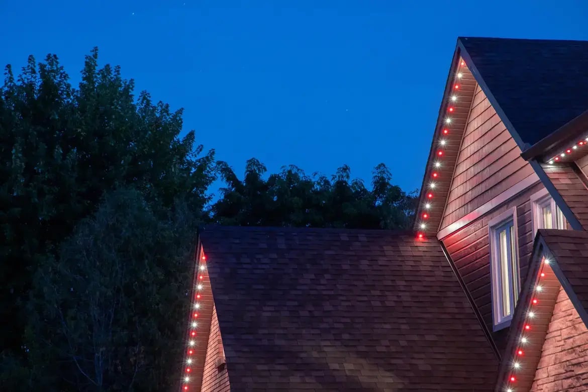 Smart lighting installed along the roofline of a modern home at night