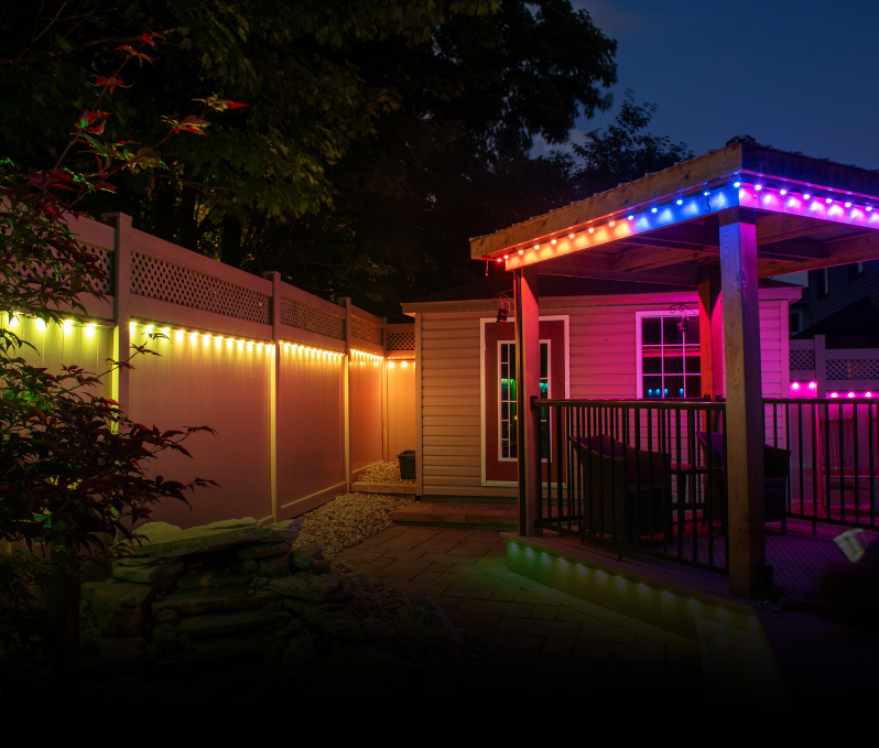Customizable permanent outdoor lighting installed on a residential backyard structure