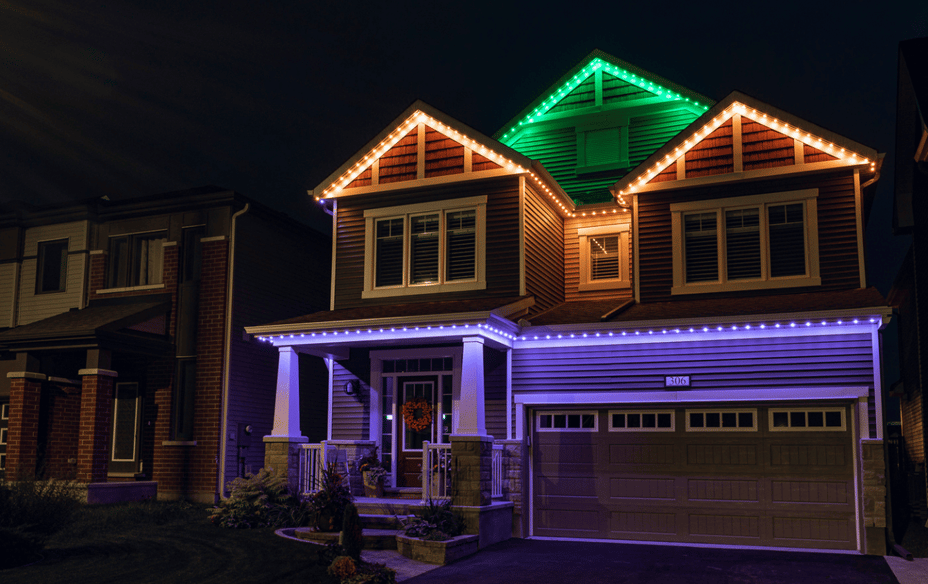 Two-storey home with Permanent Holiday Lighting using zones for a layered Halloween display.