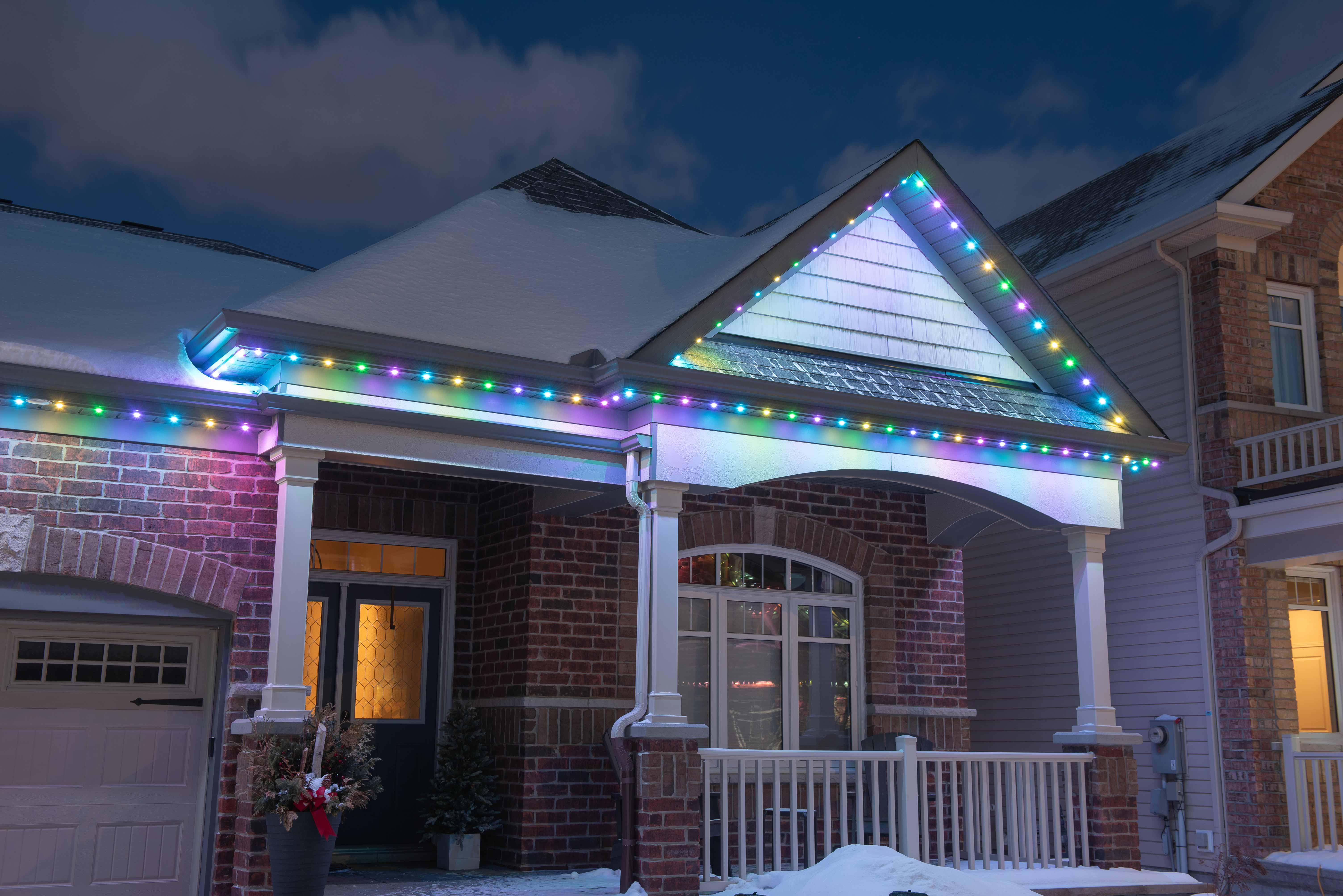 House at night with Celebright permanent lights showing the Easter Eggs preset.