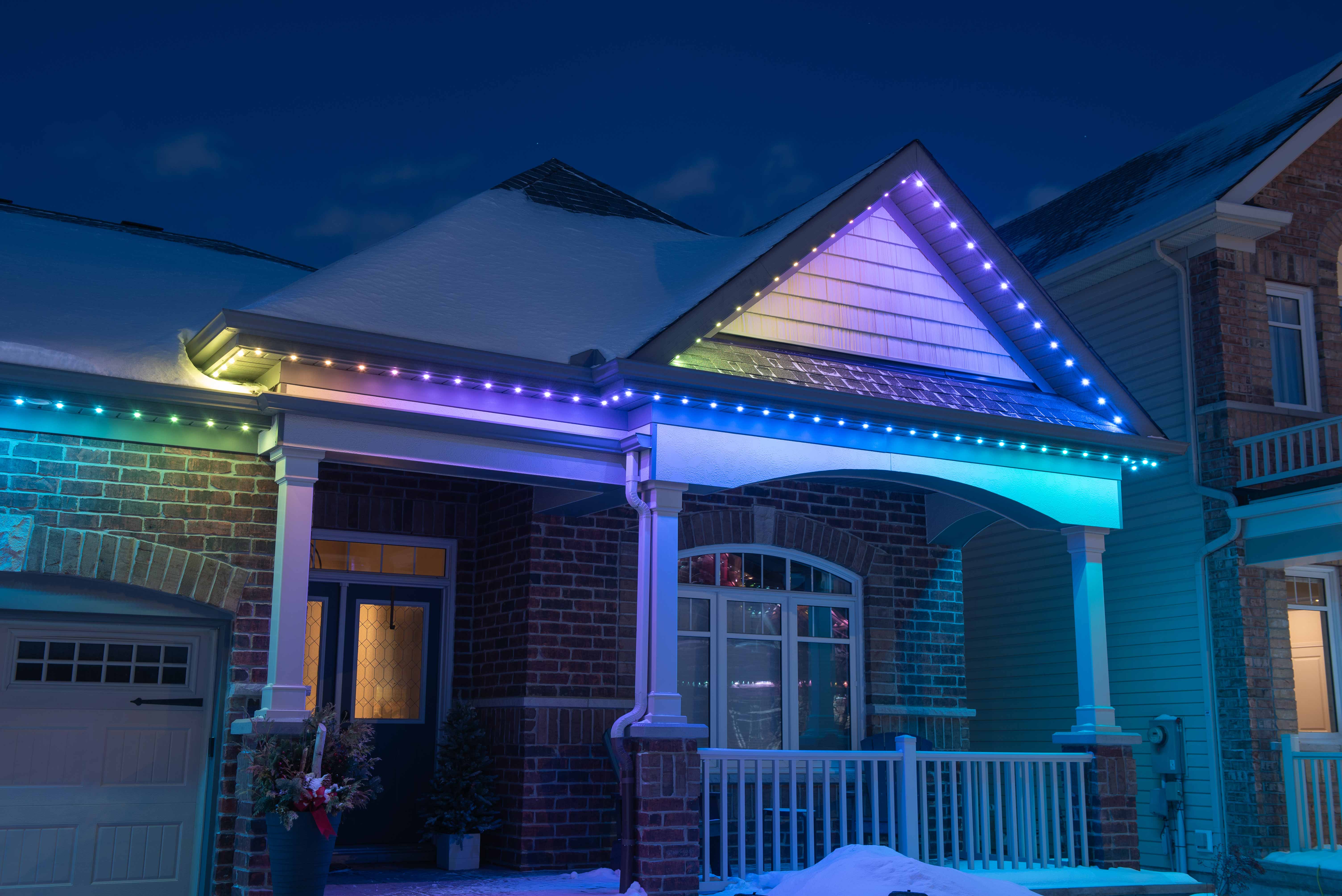 House at night with Celebright permanent lights showing the Unicorn Fart preset.