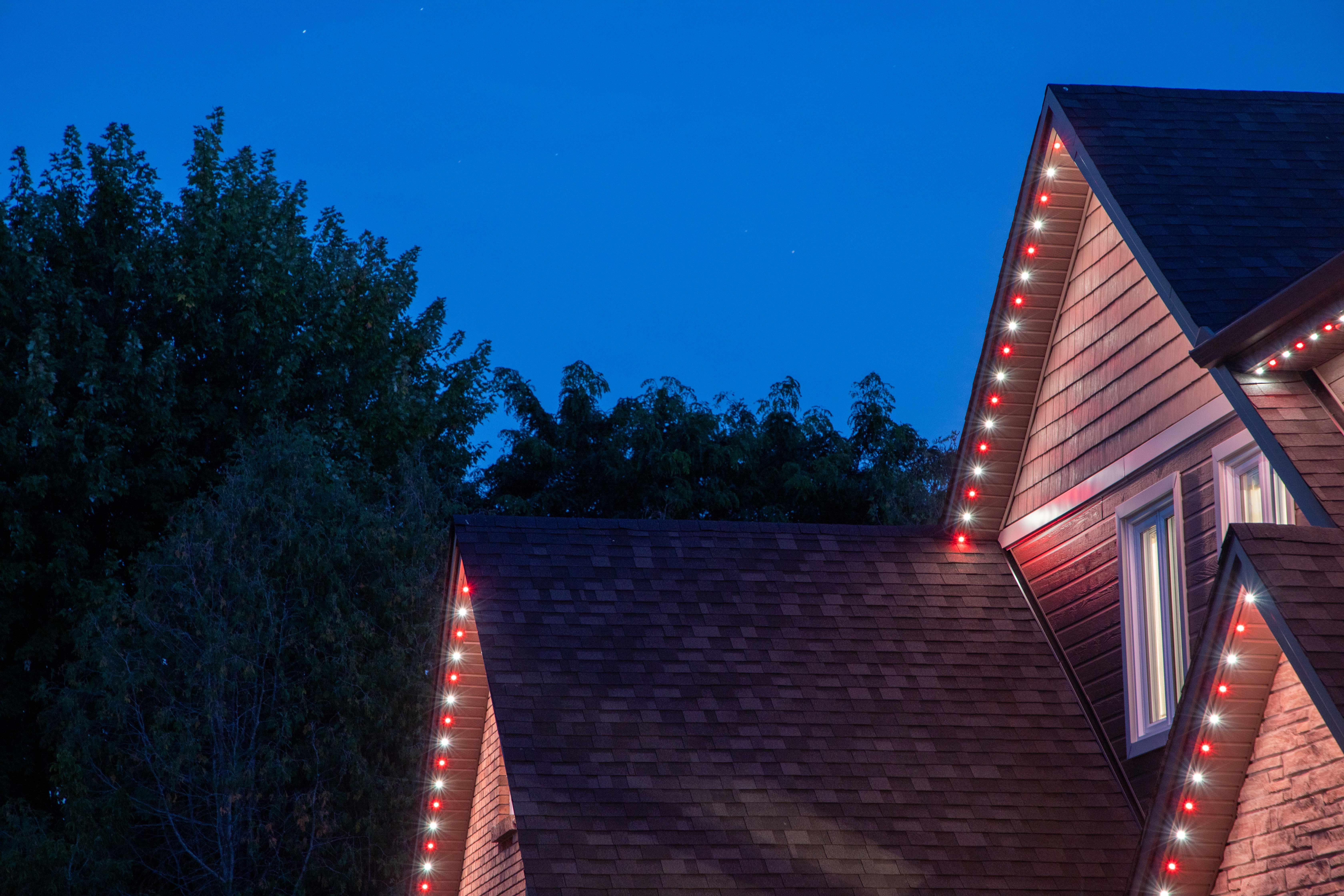 Smart lighting installed along the roofline of a modern home at night