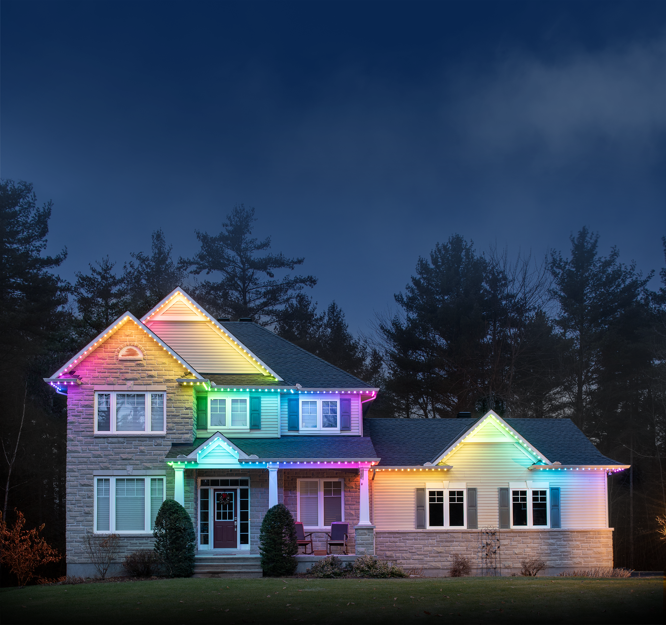A house with permanent holiday lighting installed, glowing in the rainbow preset.