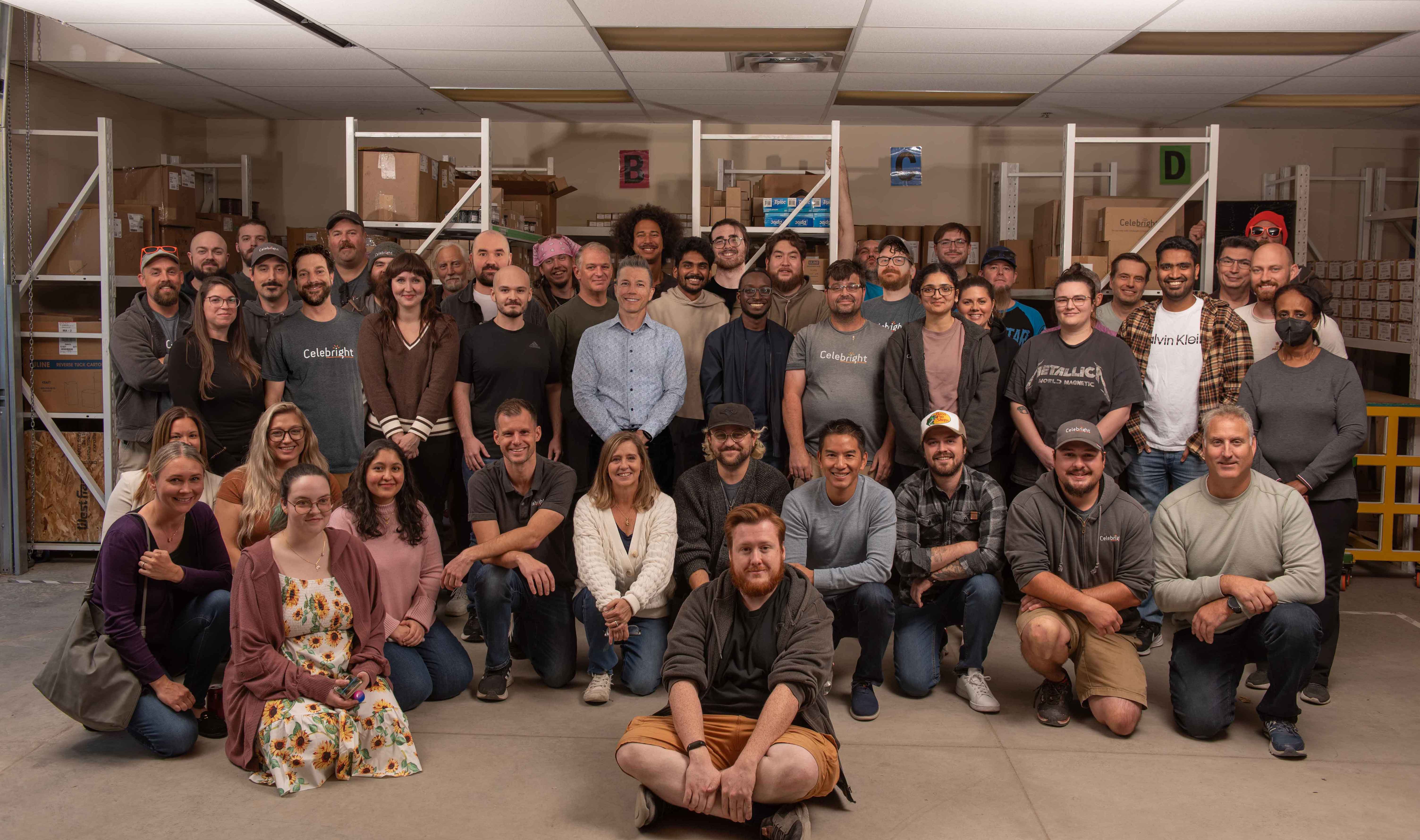 Red, green, and white permanent Christmas lights outlining the roofline of a house in a festive winter scene.