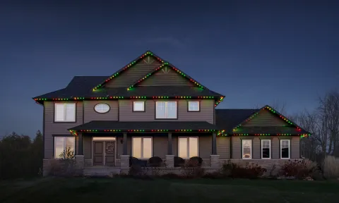 Exterior view of a house with permanent holiday lights installed for year-round use